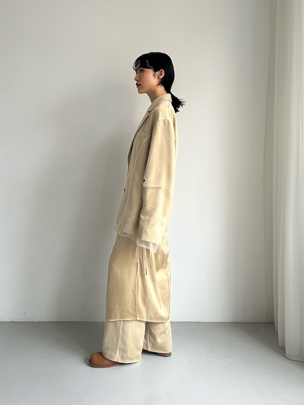 ベージュ系のその他アウター、ベージュ系のワンピース、ベージュ系のその他パンツを着用したレディースの秋コーディネートの2枚目の写真