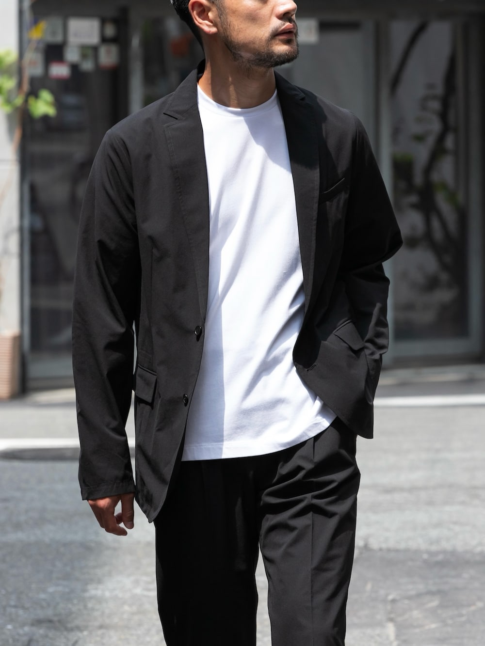 ブラック系のセットアップ、ホワイト系のTシャツ/カットソーを着用したメンズの秋コーディネートの3枚目の写真