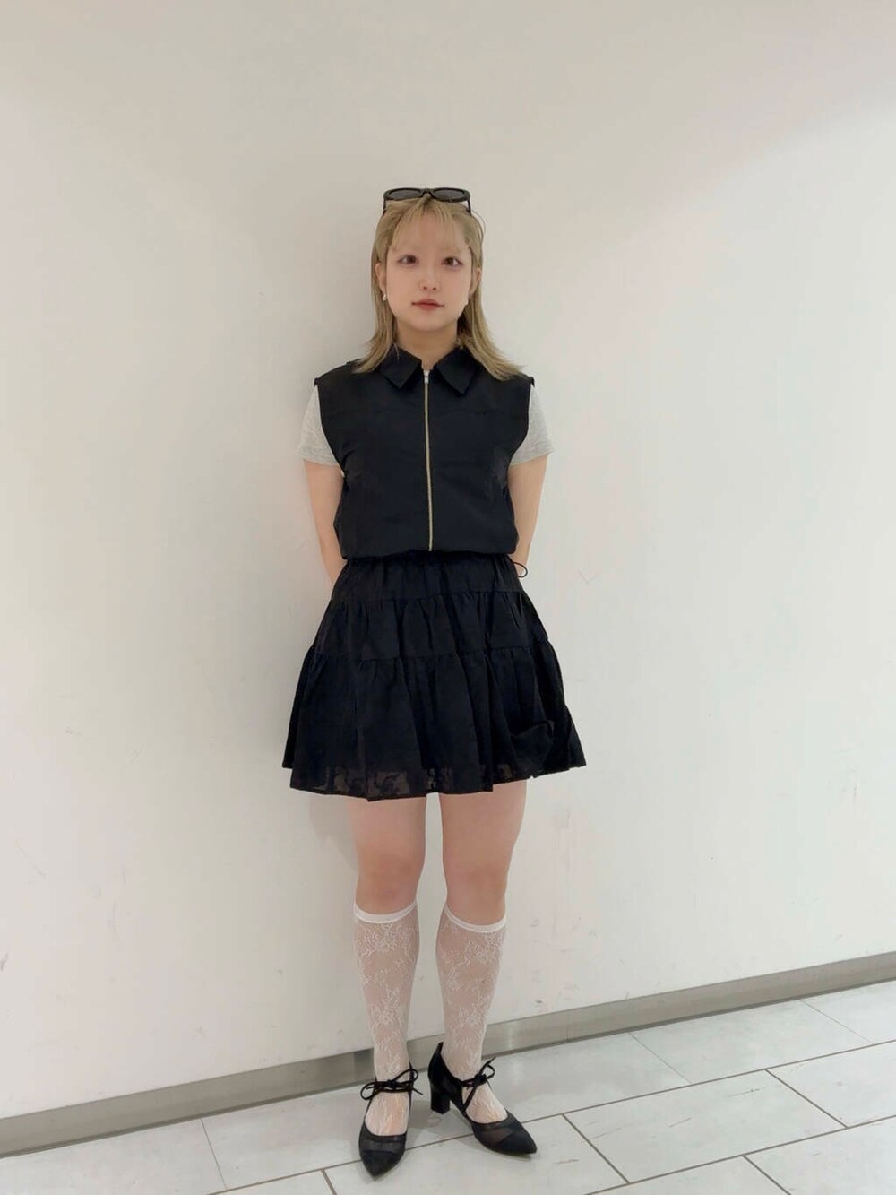ブラック系のベスト、ブラック系のパンプス、ブラック系のスカートを着用したレディースの夏コーディネートの5枚目の写真