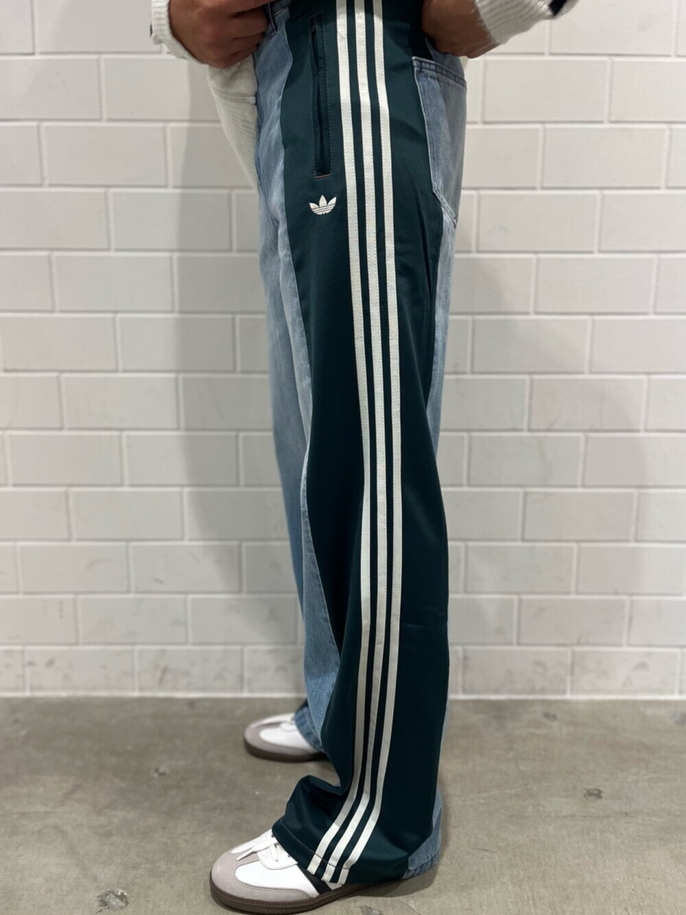 ホワイト系のジャージ、ブルー系のデニムパンツ、ブラック系のショルダーバッグを着用したメンズの秋コーディネートの5枚目の写真