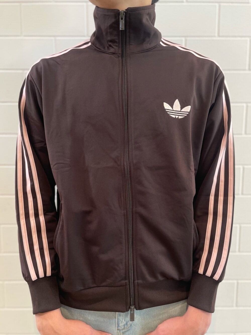 ブラウン系のジャージ、ブルー系のデニムパンツ、ブラック系のショルダーバッグを着用したメンズの春コーディネートの3枚目の写真