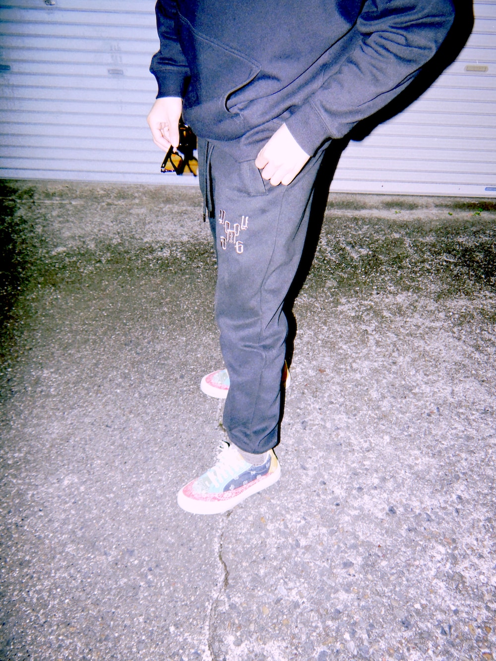 ブラック系のスウェットパンツ、ブラック系のパーカー、ブラック系のキャップを着用したメンズの冬コーディネートの5枚目の写真