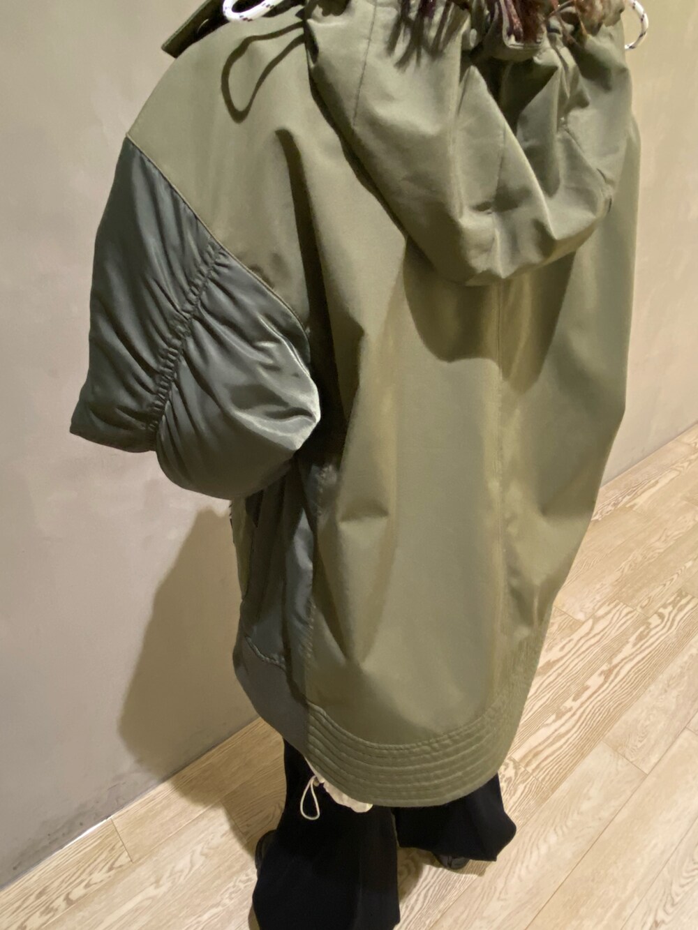 グリーン系のブルゾン、ホワイト系のシャツ/ブラウス、ブラック系のその他パンツを着用したレディースの秋コーディネートの7枚目の写真