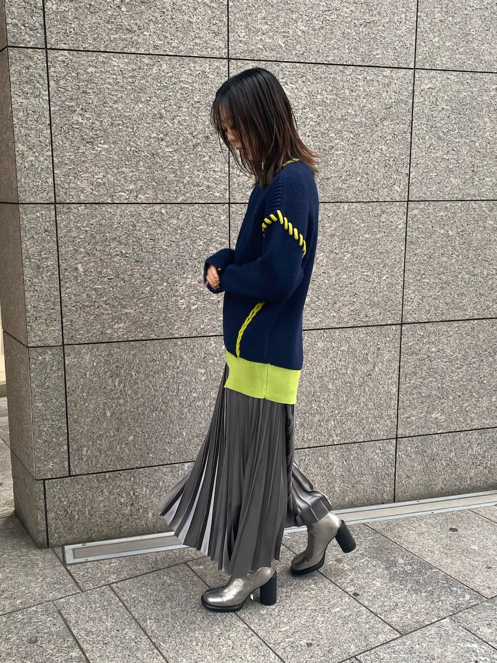 ブルー系のニット/セーター、グレー系のスカート、シルバー系のブーツを着用したレディースの冬コーディネートの3枚目の写真