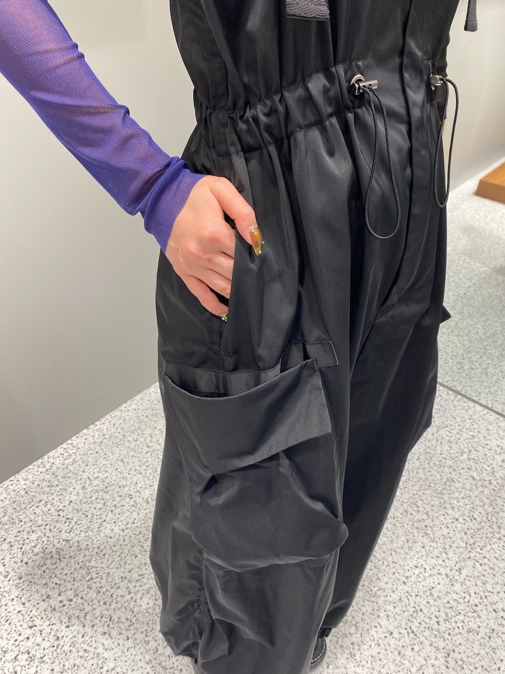 ブラック系のワンピース、ブラック系のTシャツ/カットソー、ブラック系のブーツを着用したレディースの秋コーディネートの6枚目の写真