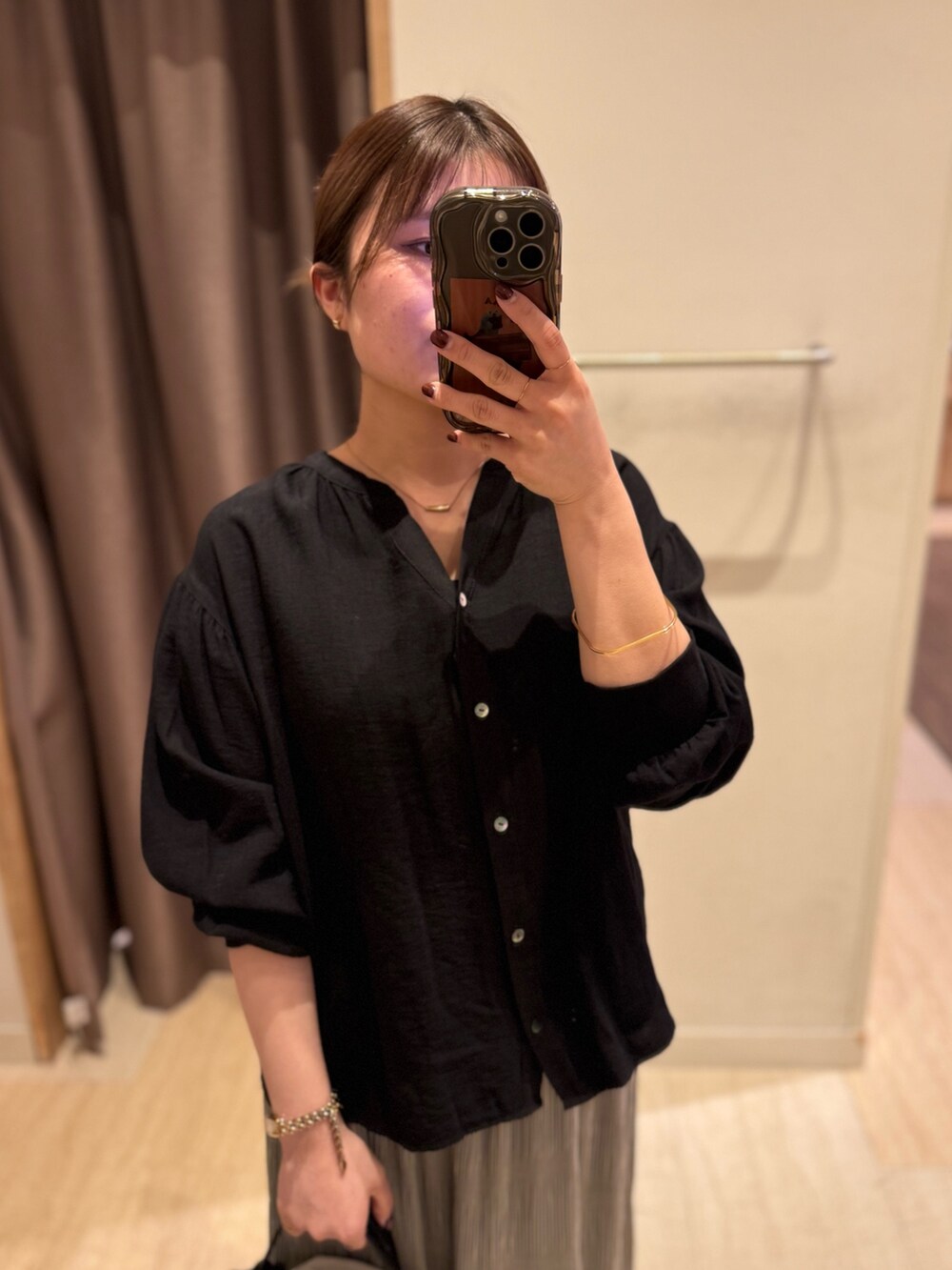 ブラック系のシャツ/ブラウス、グレー系のスカート、ブラック系のトートバッグを着用したレディースの春コーディネートの2枚目の写真