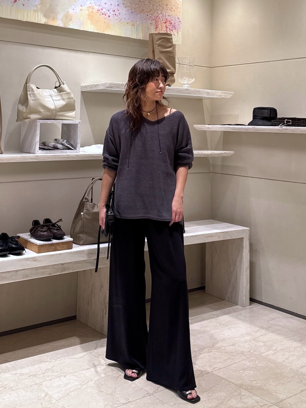 ブラック系のその他パンツ、グレー系のニット/セーター、ブラック系のサンダルを着用したレディースの春コーディネートの2枚目の写真