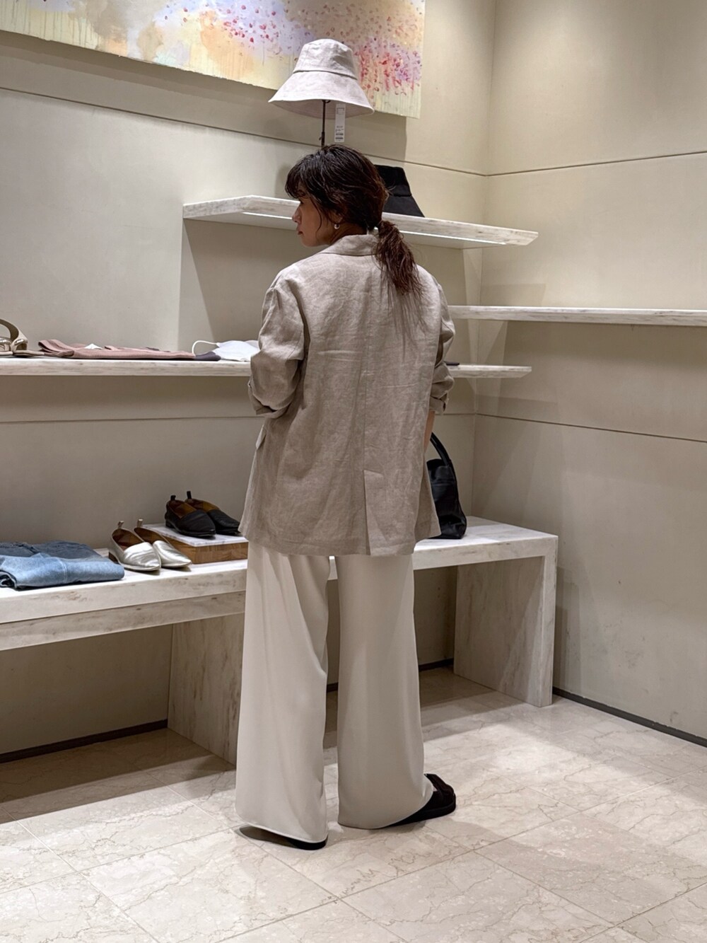ベージュ系のその他パンツ、ブラウン系のサンダル、ホワイト系のその他アウターを着用したレディースの春コーディネートの2枚目の写真