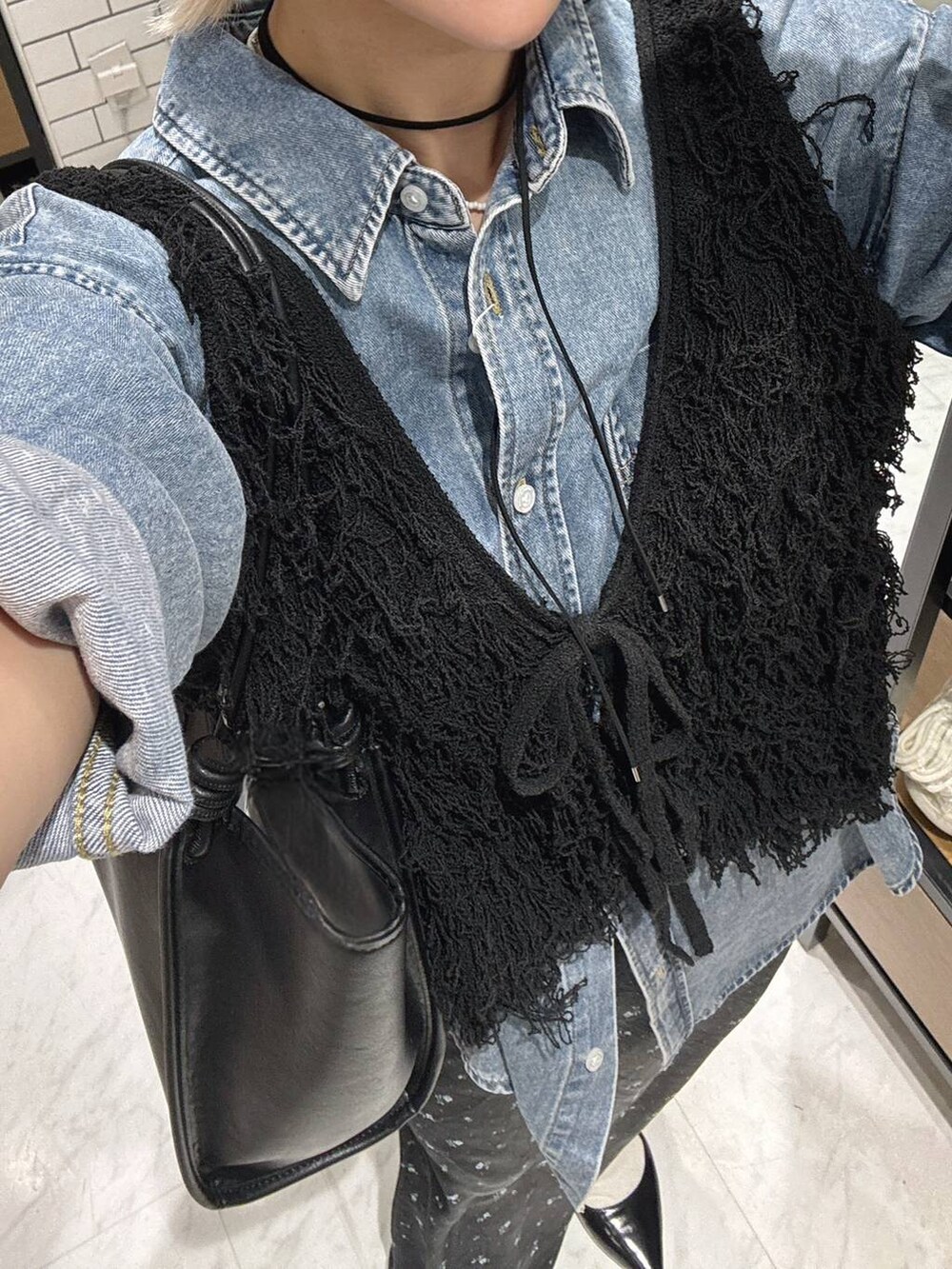 ブラック系のスカート、ブラック系のパンプス、ブルー系のシャツ/ブラウスを着用したレディースの春コーディネートの5枚目の写真