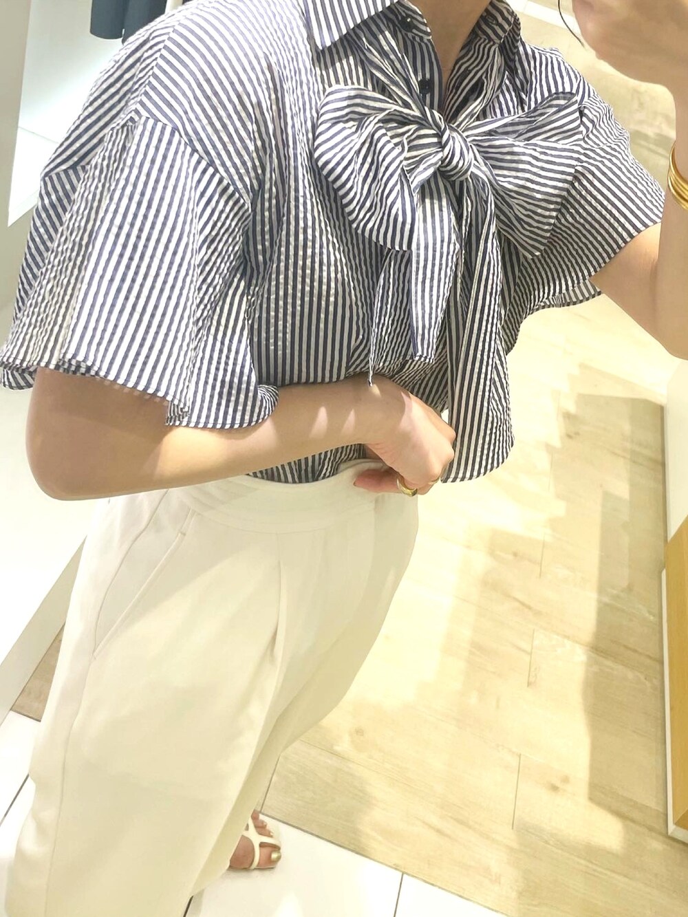 ホワイト系のその他パンツ、ホワイト系のショルダーバッグ、ブルー系のシャツ/ブラウスを着用したレディースの春コーディネートの7枚目の写真