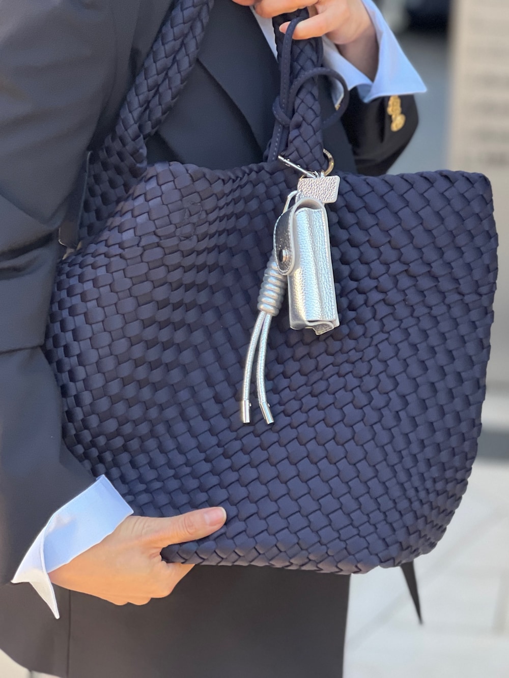 ブルー系のテーラードジャケット、ブルー系のトートバッグ、グレー系のスウェットパンツを着用したレディースの春コーディネートの5枚目の写真