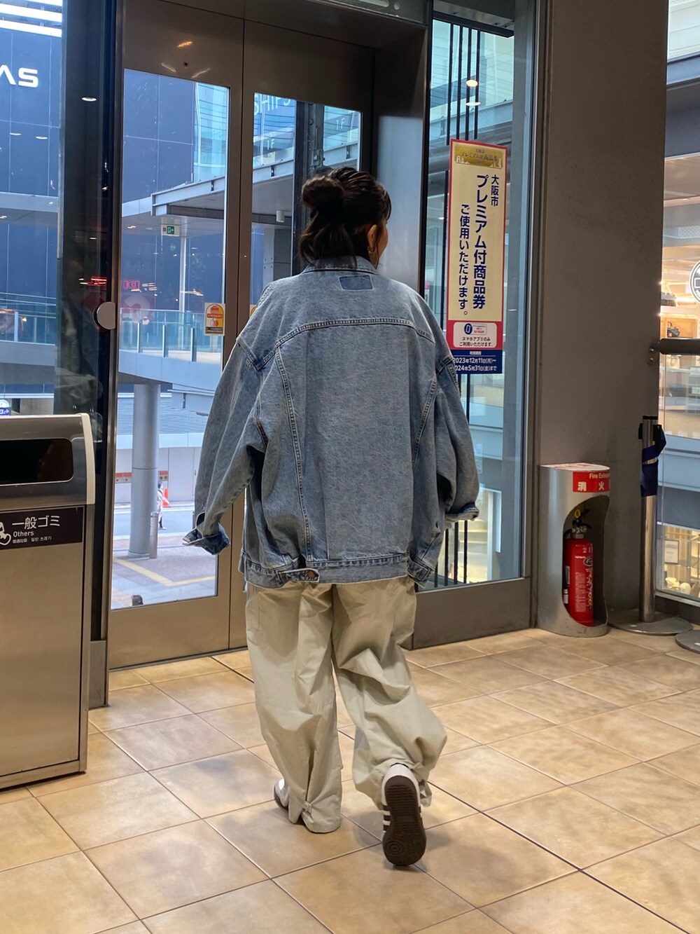 ブルー系のデニムジャケット、グレー系のサロペット/オーバーオール、ゴールド系のネックレスを着用したレディースの冬コーディネートの4枚目の写真