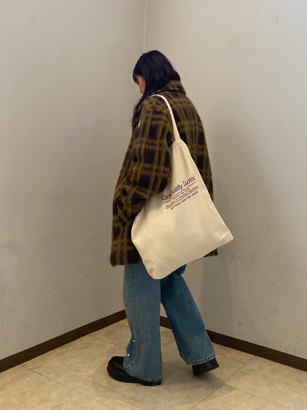 その他のピーコート、ブルー系のデニムパンツ、ブラック系のニット/セーターを着用したレディースの冬コーディネートの3枚目の写真