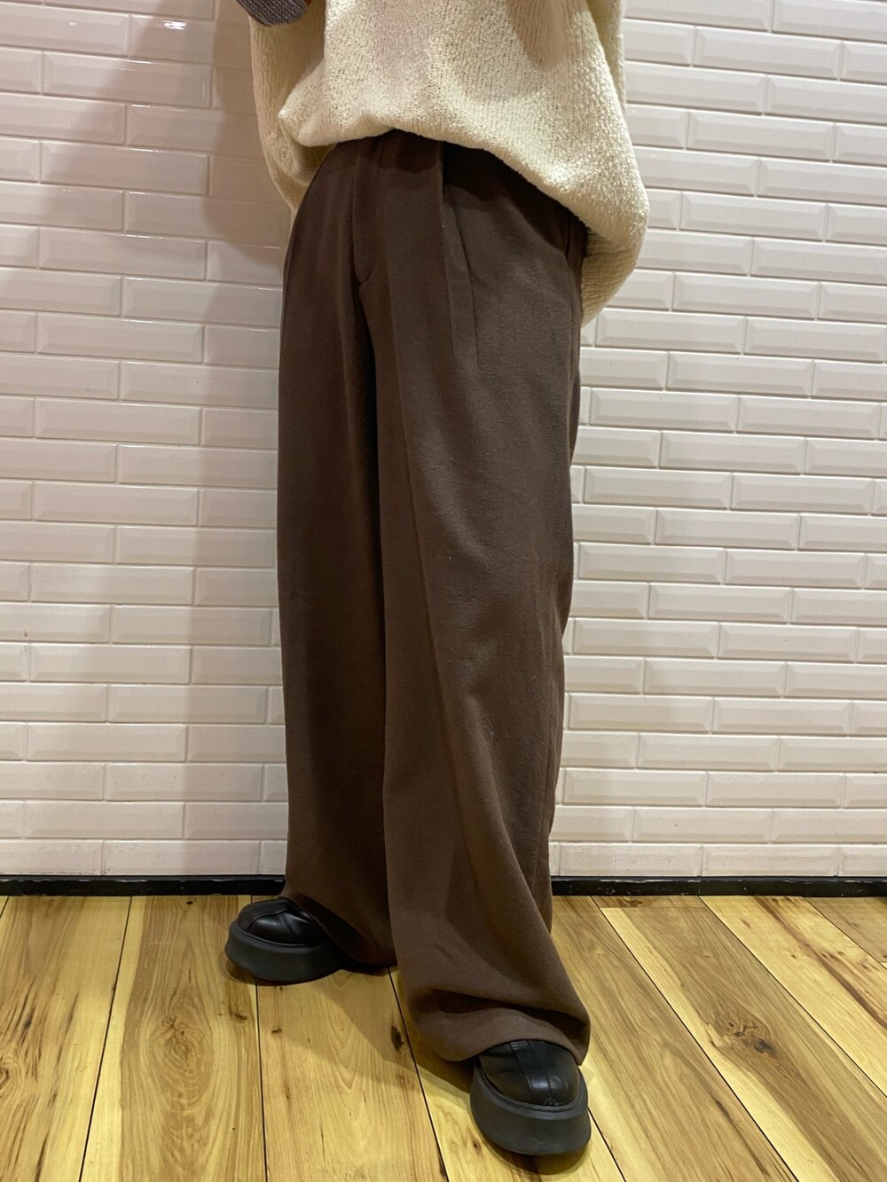 ホワイト系のニット/セーター、ブラウン系のその他パンツ、グレー系のハンドバッグを着用したレディースの冬コーディネートの5枚目の写真