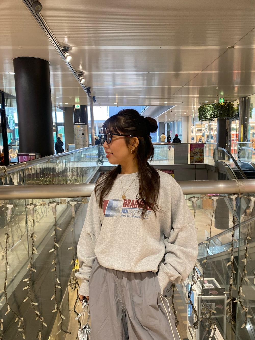 グレー系のスウェット、ブルー系のその他パンツ、ブラック系のサングラスを着用したレディースの冬コーディネートの4枚目の写真