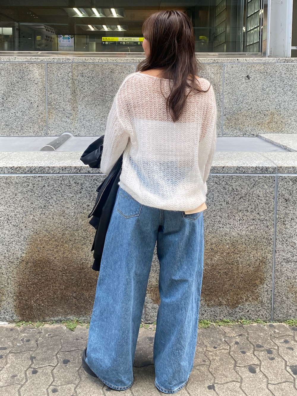 ホワイト系のニット/セーター、ブルー系のデニムパンツを着用したレディースの秋コーディネートの3枚目の写真