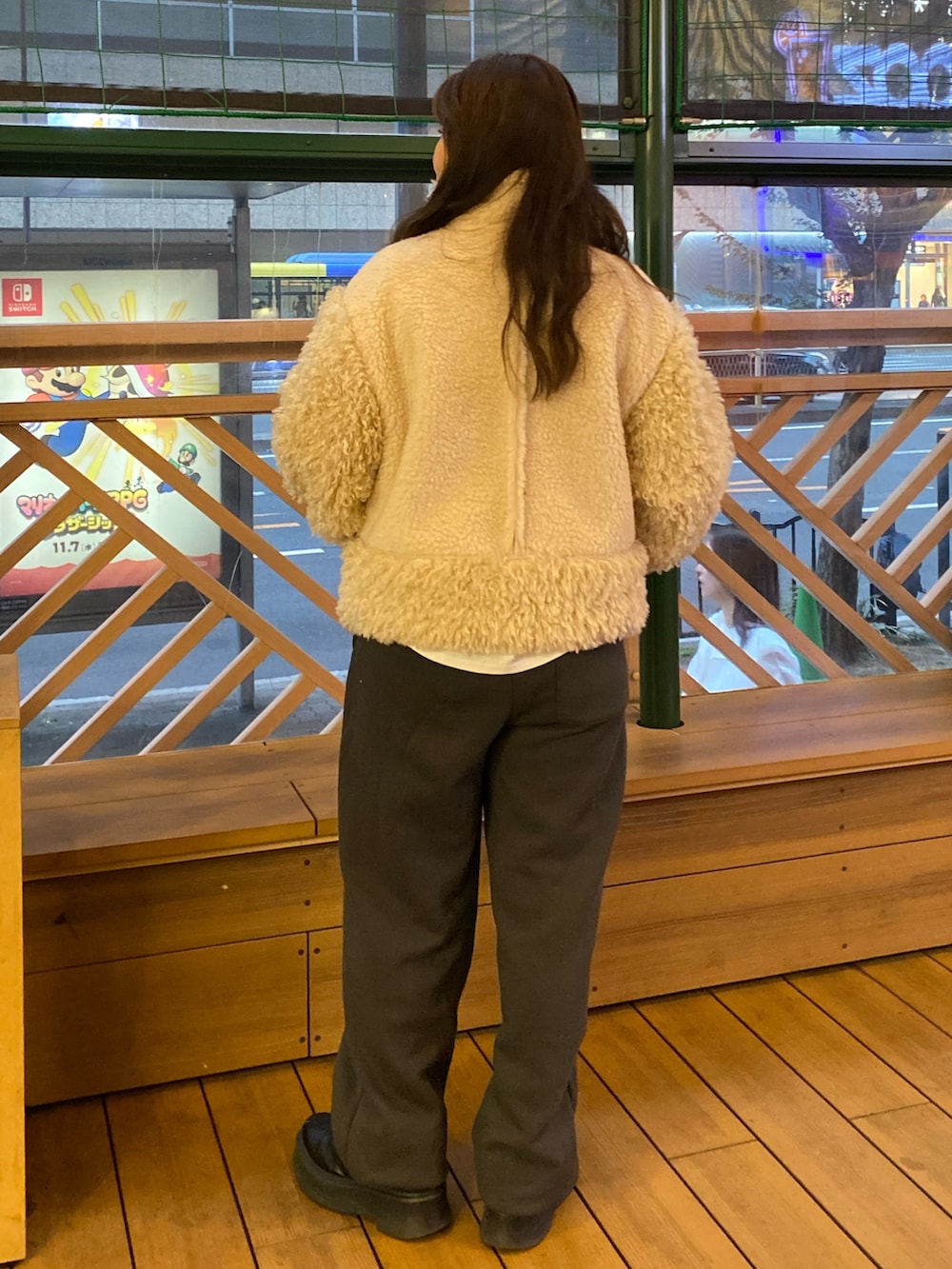 ホワイト系のムートンコート、グレー系のスウェットパンツを着用したレディースの冬コーディネートの3枚目の写真