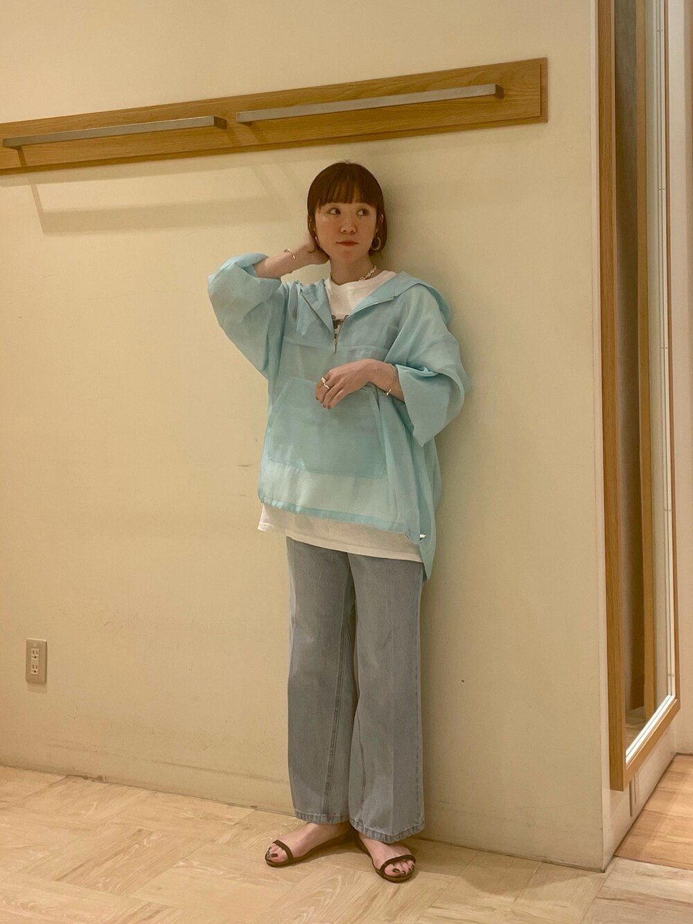 ブルー系のブルゾン、ブルー系のデニムパンツ、ブラック系のサンダルを着用したレディースの春コーディネートの3枚目の写真