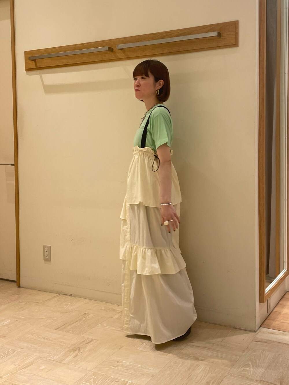 ホワイト系のワンピース、グリーン系のTシャツ/カットソー、ブラック系のサンダルを着用したレディースの夏コーディネートの3枚目の写真