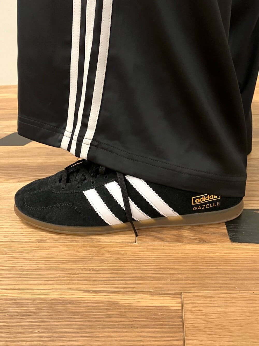 レッド系のパーカー、ブラック系のスウェットパンツ、ブラック系のスニーカーを着用したメンズの冬コーディネートの4枚目の写真