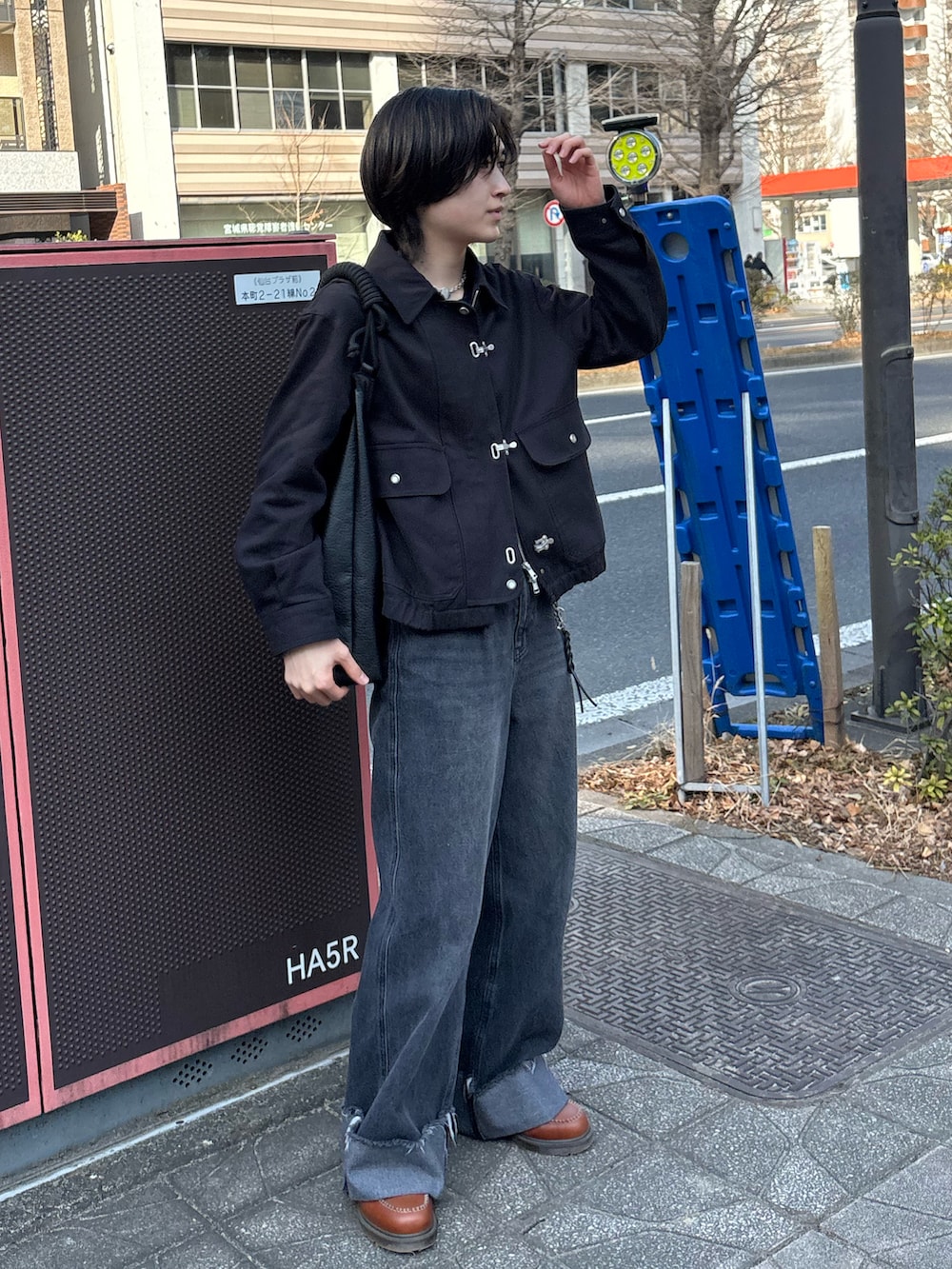 ブラック系のブルゾン、ブラック系のデニムパンツ、ブラック系のトートバッグを着用したメンズの春コーディネートの2枚目の写真