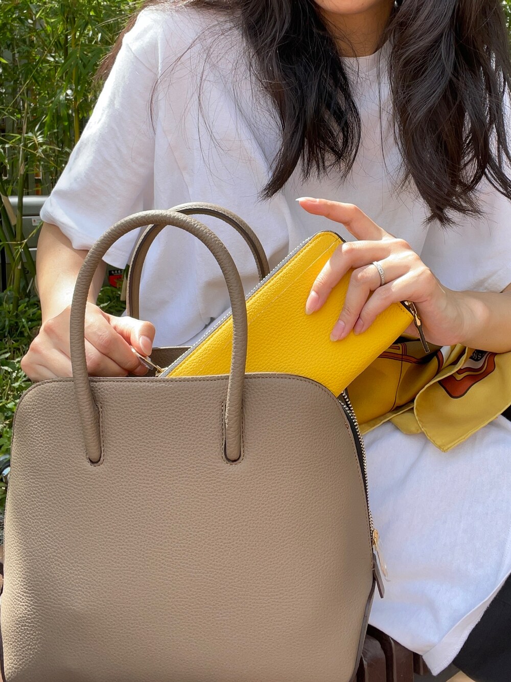 ベージュ系のボストンバッグ、イエロー系の財布を着用したレディースの秋コーディネートの3枚目の写真