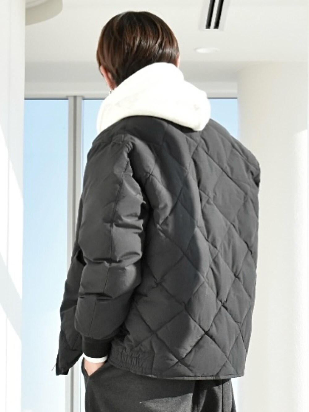 ホワイト系のパーカー、ブラック系のダウンジャケット/コート、ブラック系のトップスを着用したメンズの冬コーディネートの4枚目の写真