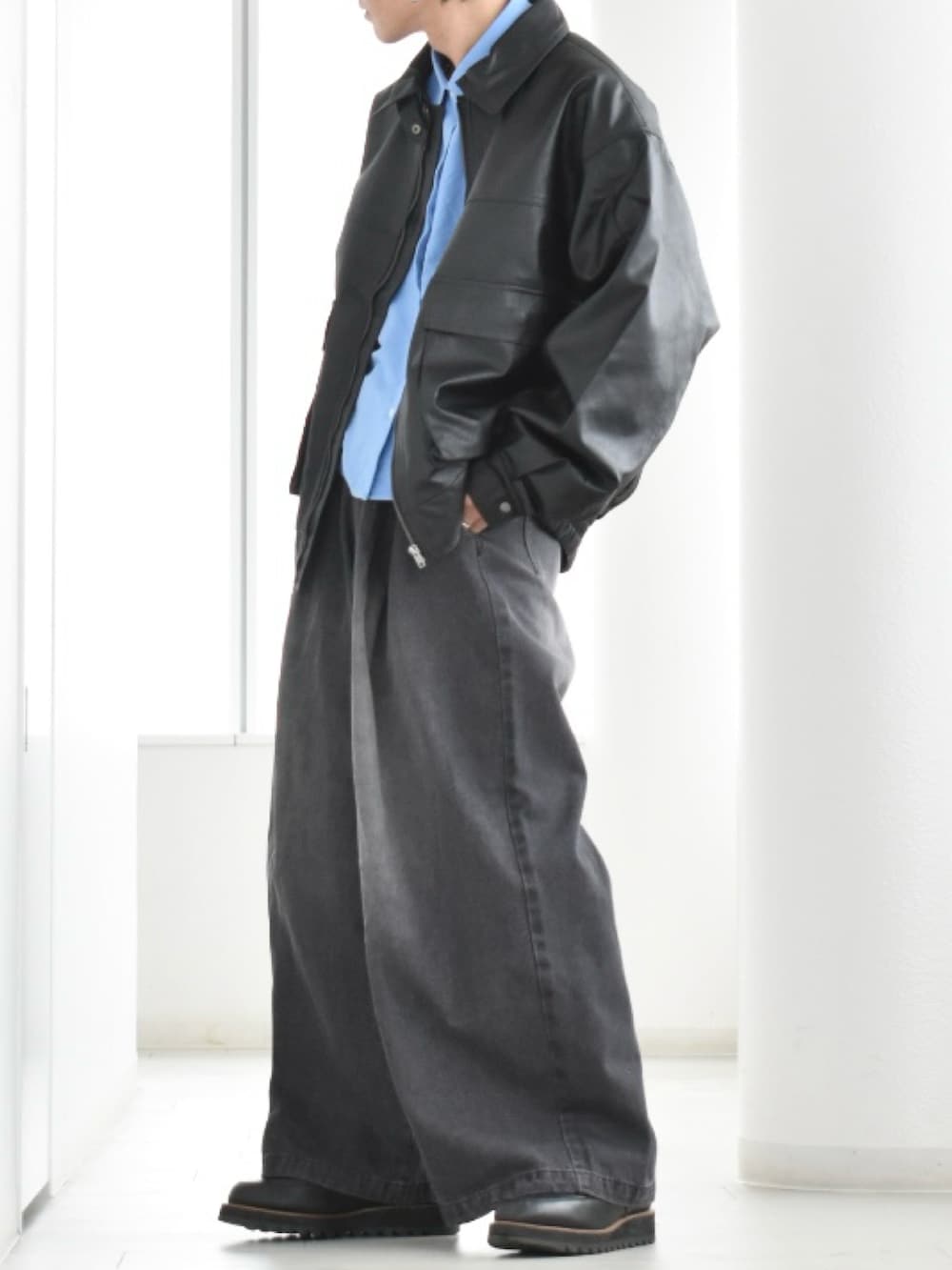 ブラック系のブルゾン、ブラック系のデニムパンツ、ブルー系のシャツ/ブラウスを着用したメンズの春コーディネートの2枚目の写真