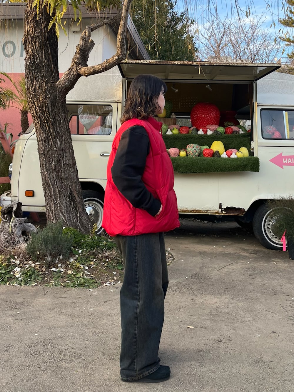 レッド系のナイロンジャケット、ブラック系のモカシン/デッキシューズを着用したレディースの冬コーディネートの2枚目の写真