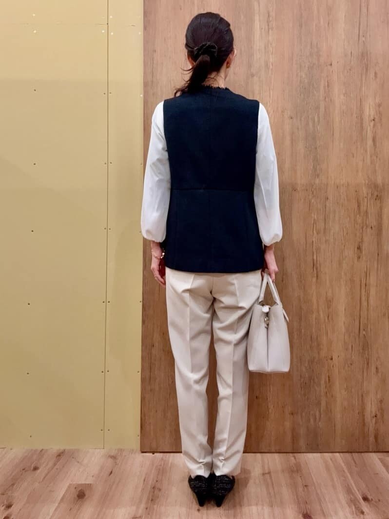 ブラック系のパンプス、ベージュ系のその他パンツ、ブルー系のベストを着用したレディースの冬コーディネートの4枚目の写真