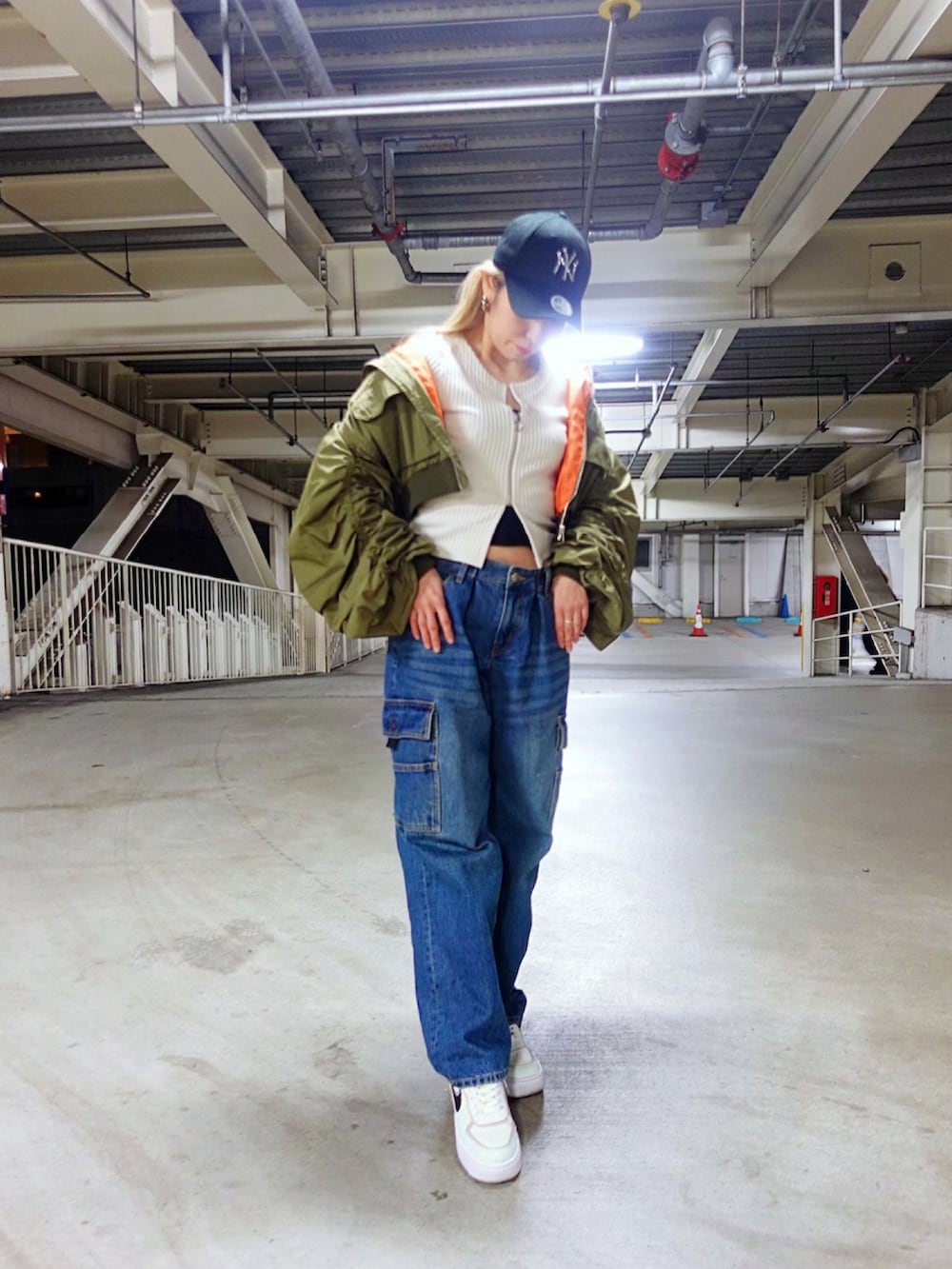 ブルー系のカーゴパンツ、グリーン系のMA-1、ホワイト系のトップスを着用したレディースの秋コーディネートの3枚目の写真