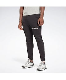 Reebok（リーボック）の「アーチ ロゴ スウェット ジョガーパンツ / RI Arch Logo Jogger （アウトドア/スポーツ・メンズ）」